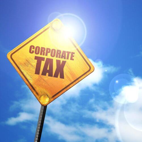 yellow sign that reads corporate tax