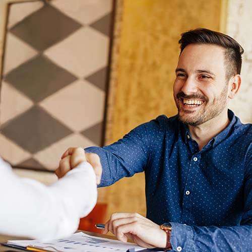 Business man shaking hands over a table