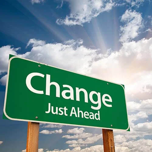Green change sign with sky in background