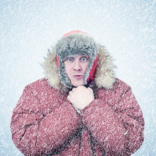 Man in winter coat with falling snow