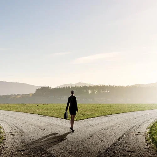 woman walking on path with two options