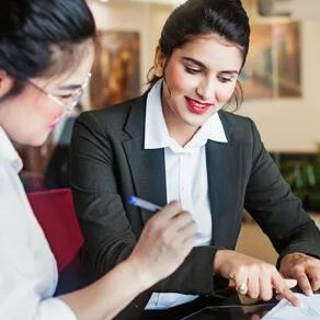 two women looking at financial